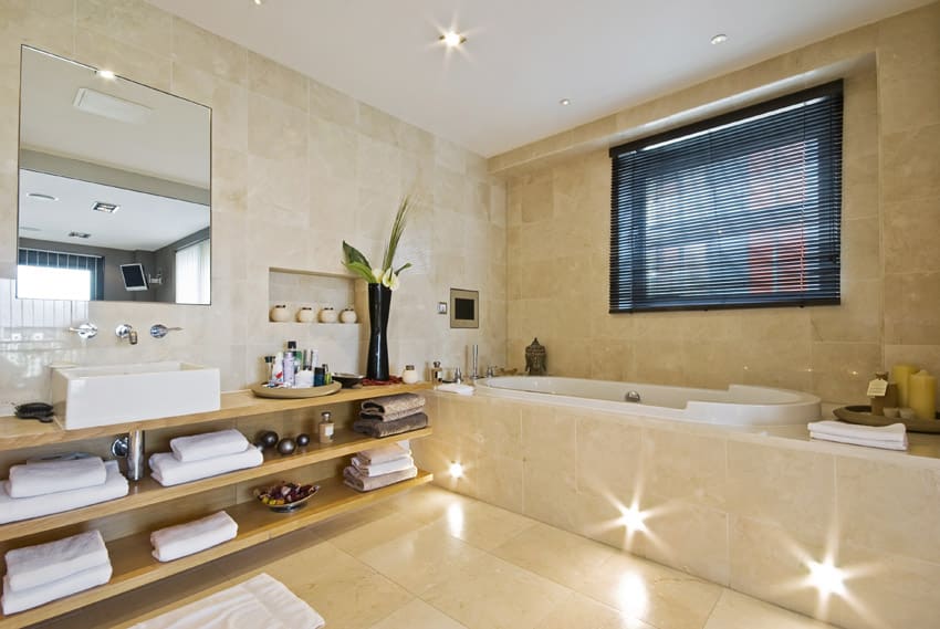 Bathtub with enclosure lighting in base
