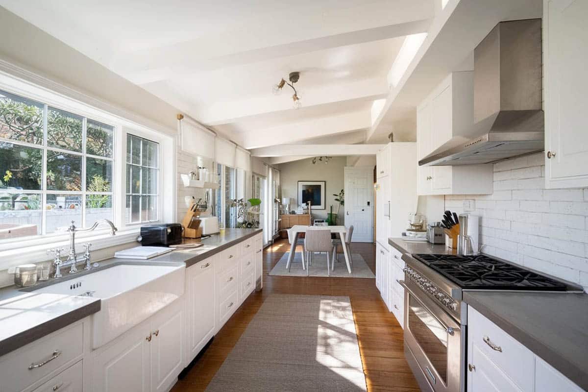 Traditional galley kitchen with white cabinets backsplash