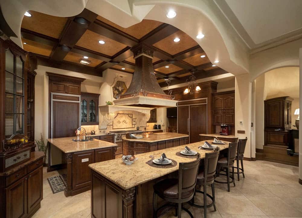 Kitchen with long dining island and limestone floors