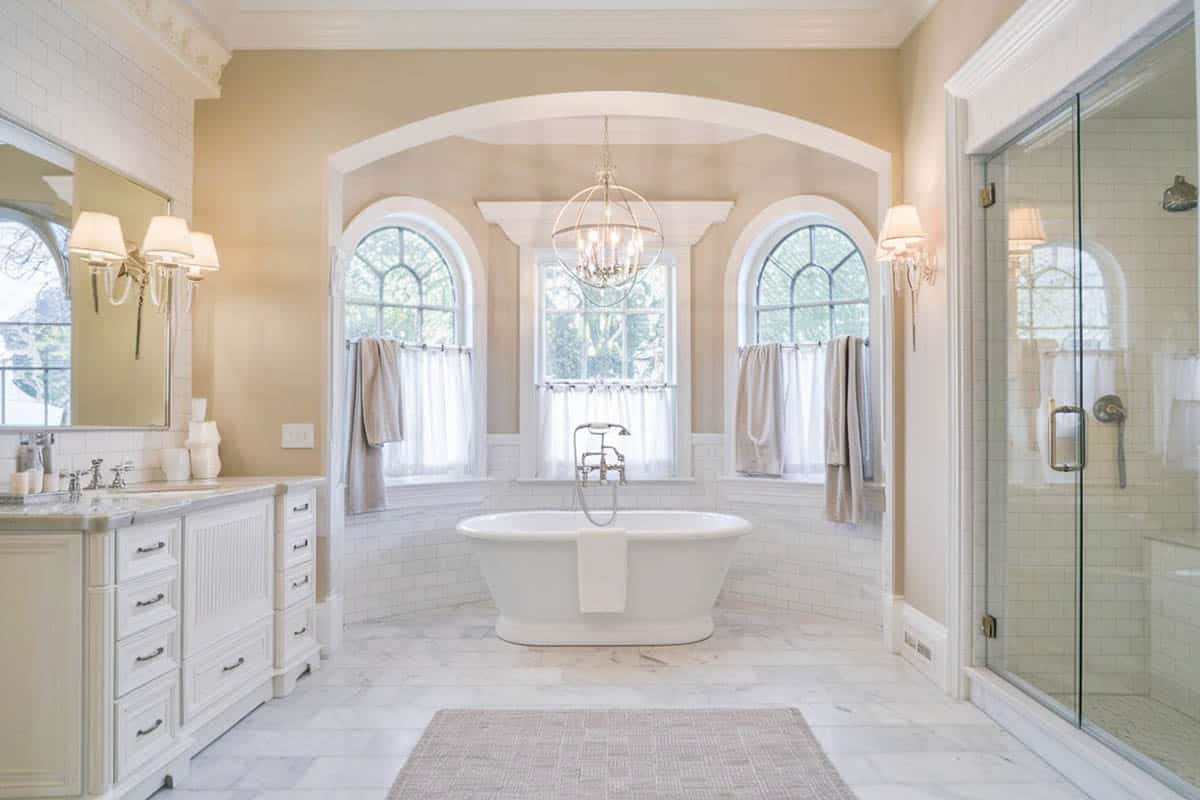 Bathroom with cast iron bathtub and curved windows
