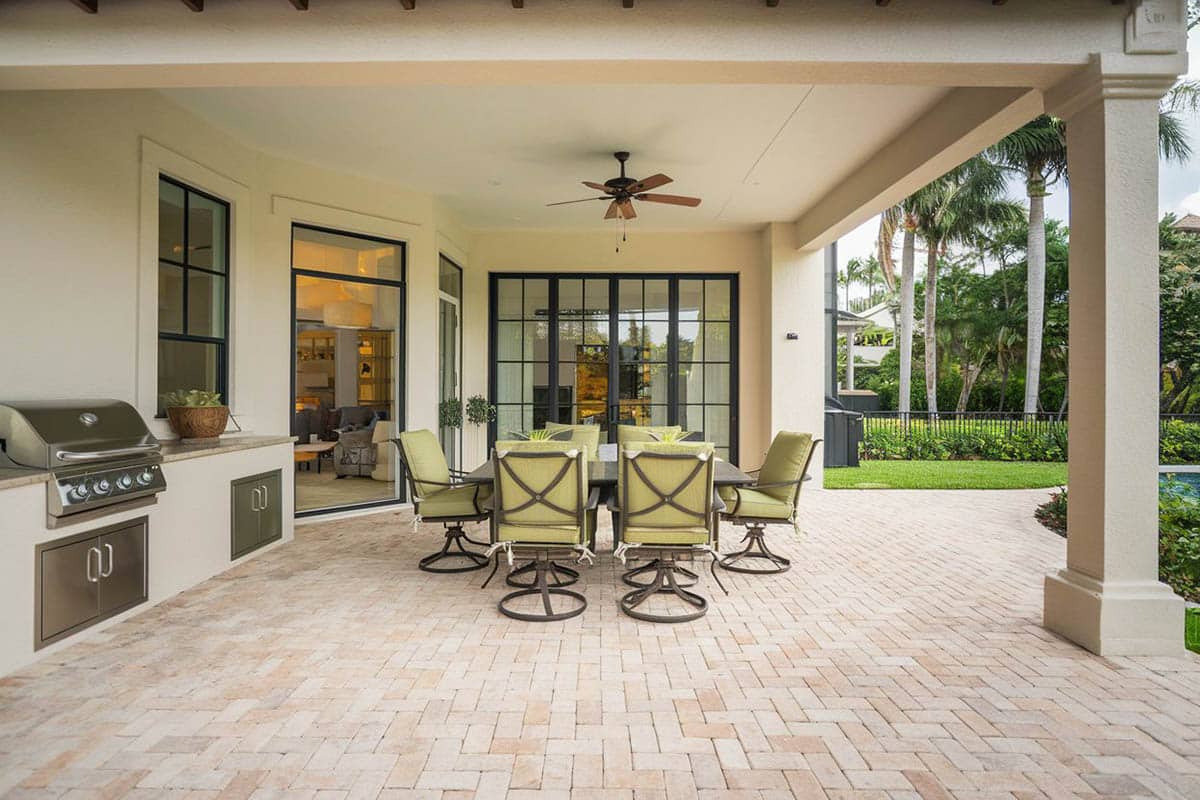 Brick paver patio with outdoor kitchen and ceiling fan
