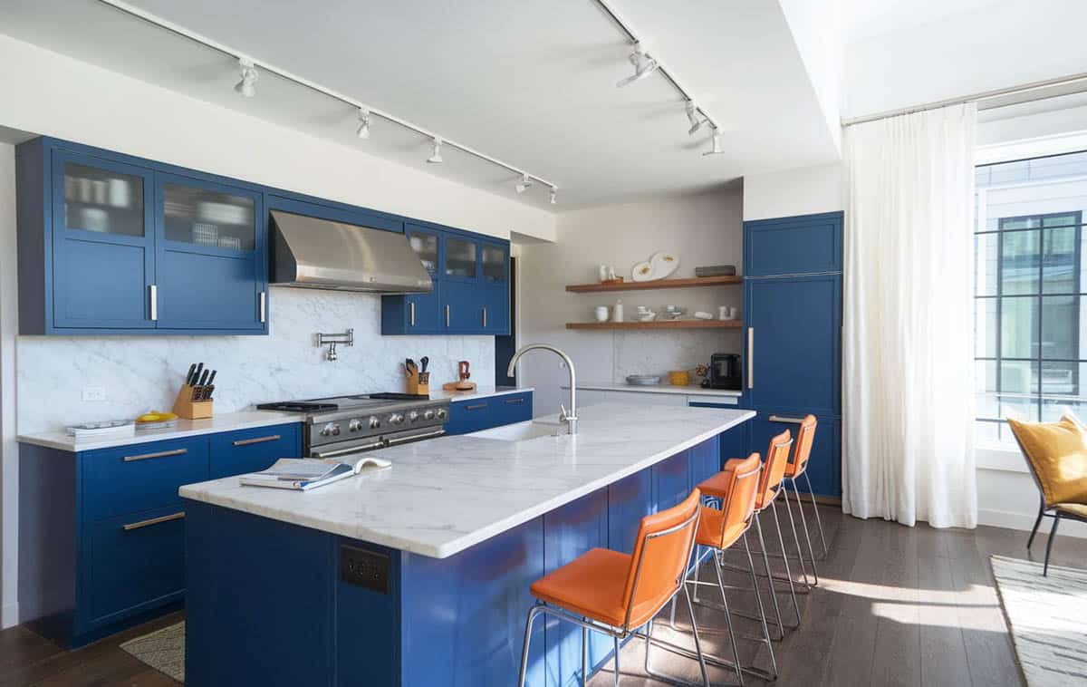 Contemporary kitchen with blue cabinets and carrara white marble countertops