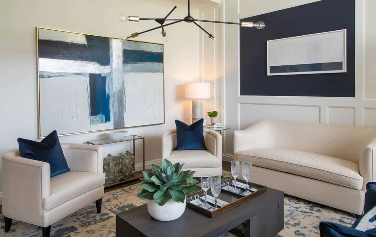Contemporary room with modern chandelier, white panels and navy accent wall