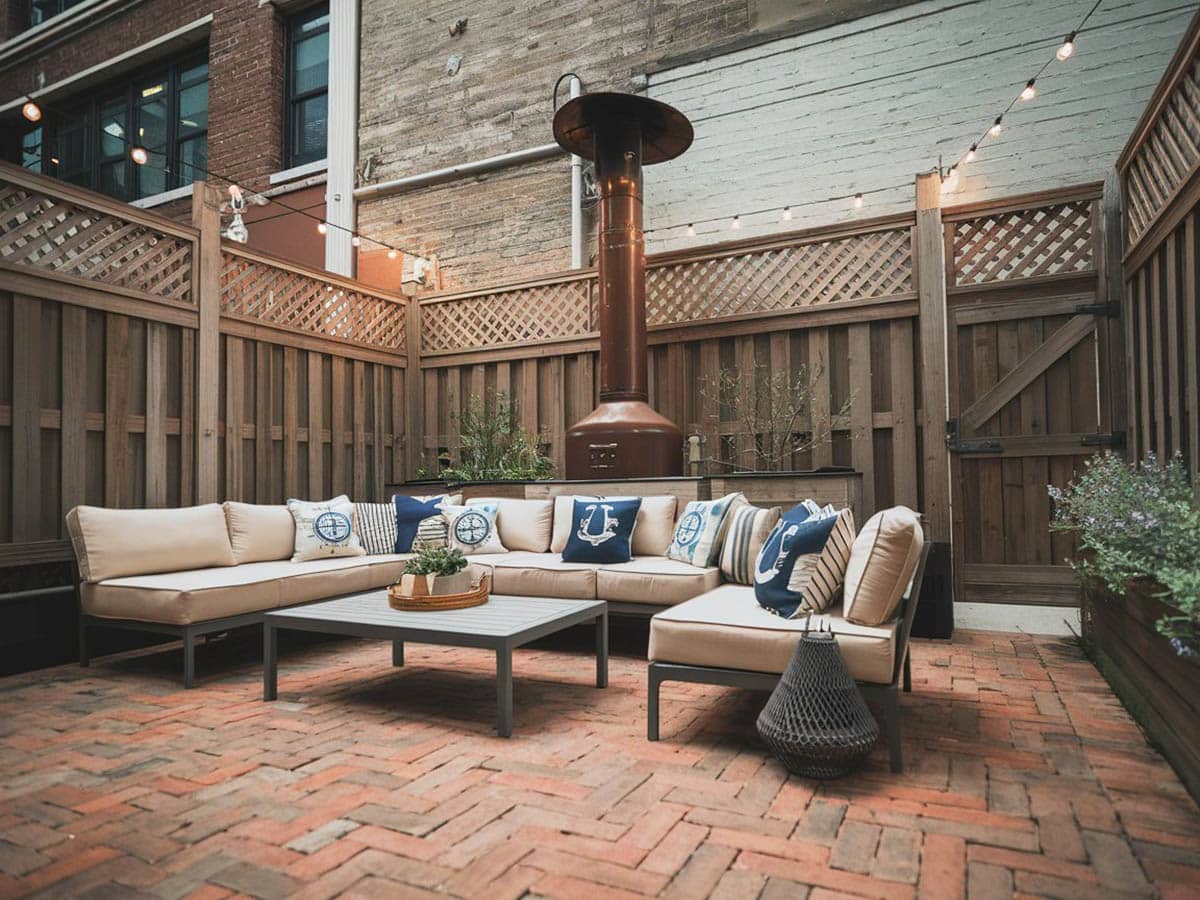 Courtyard patio with red bricks and outdoor sectional couch
