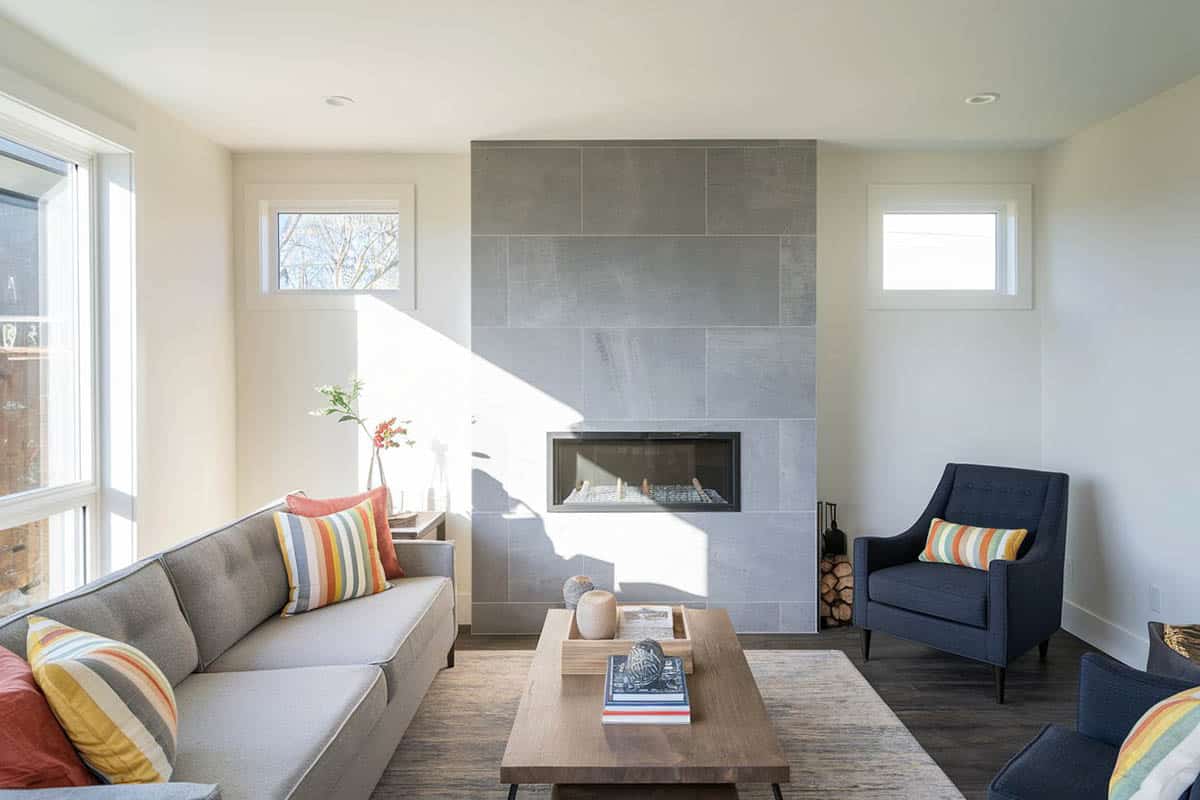 Stylish room with grey tile fireplace and engineered hardwood dark color floors