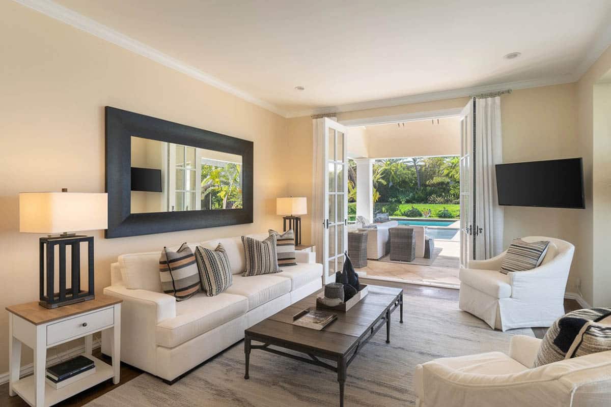 Room with wall mirror and large patio doors to pool