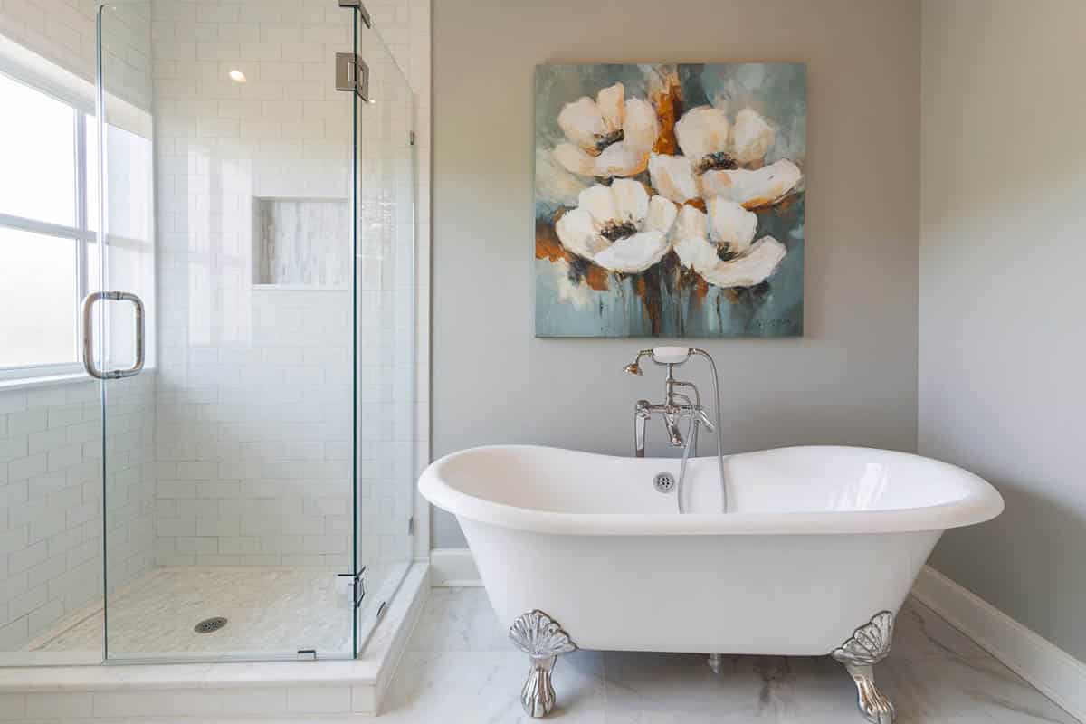 Bathroom with separate shower area and wall art