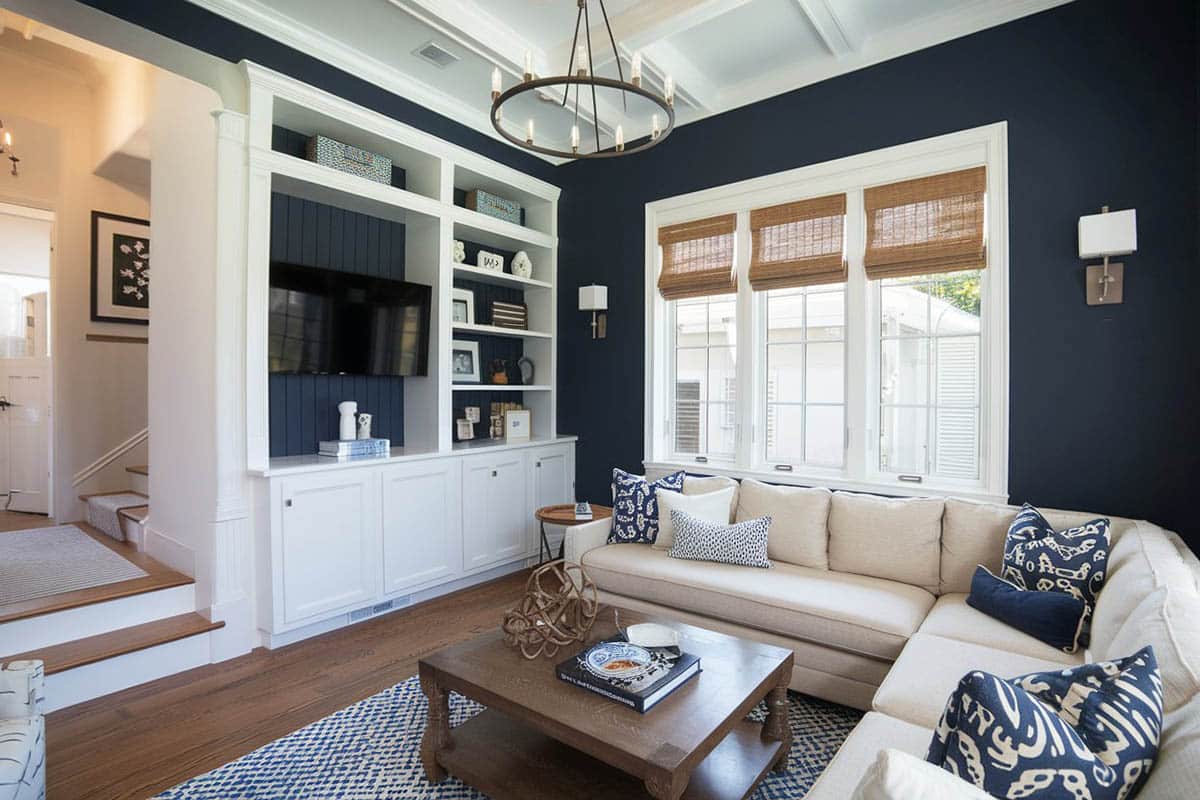 Traditional living room with dark walls and white built in bookshelf's