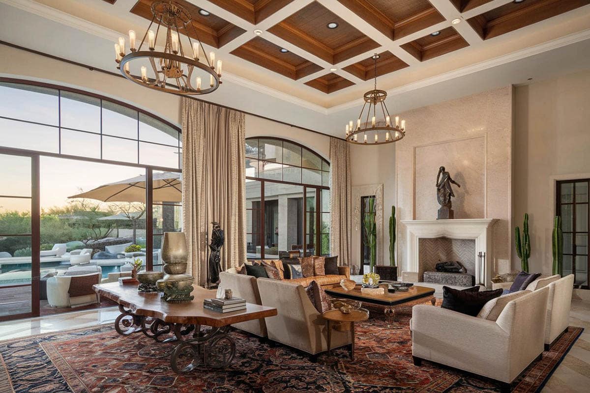 Rustic chandeliers, marble sculptures and large black framed windows