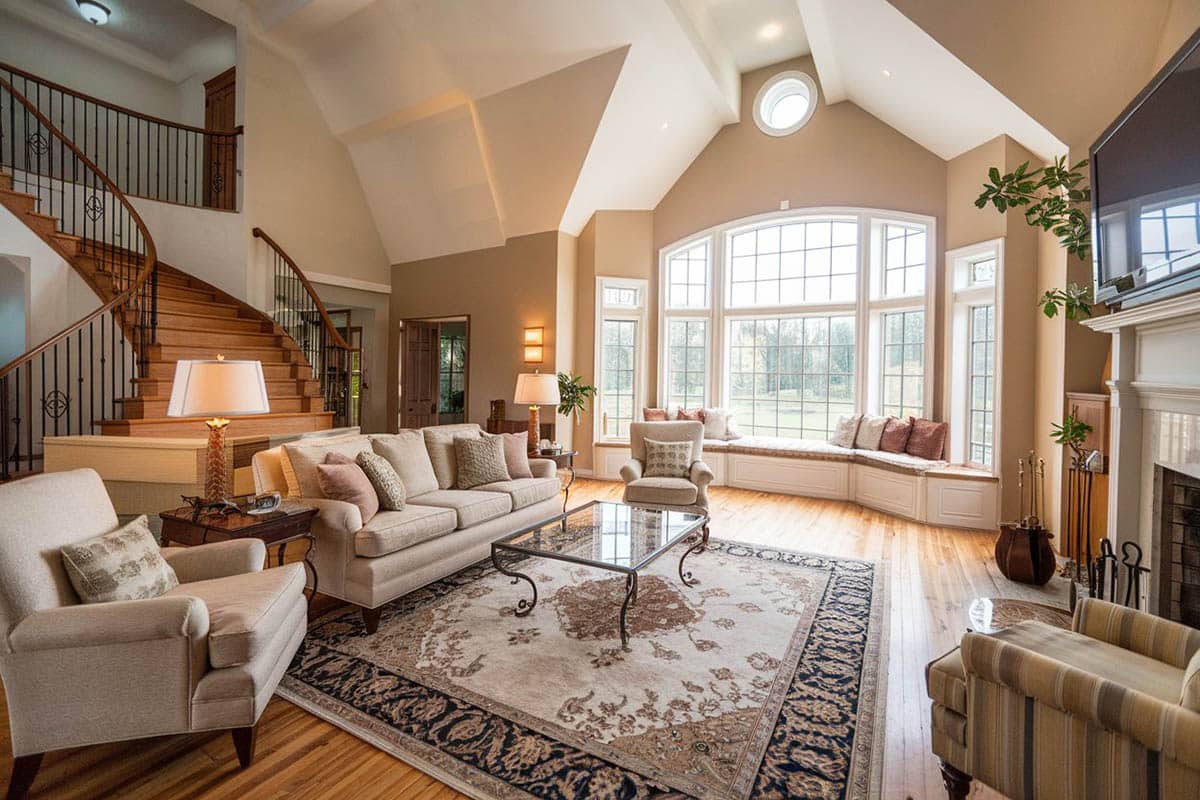 Wood floors, circular staircase, window seat and high ceiling
