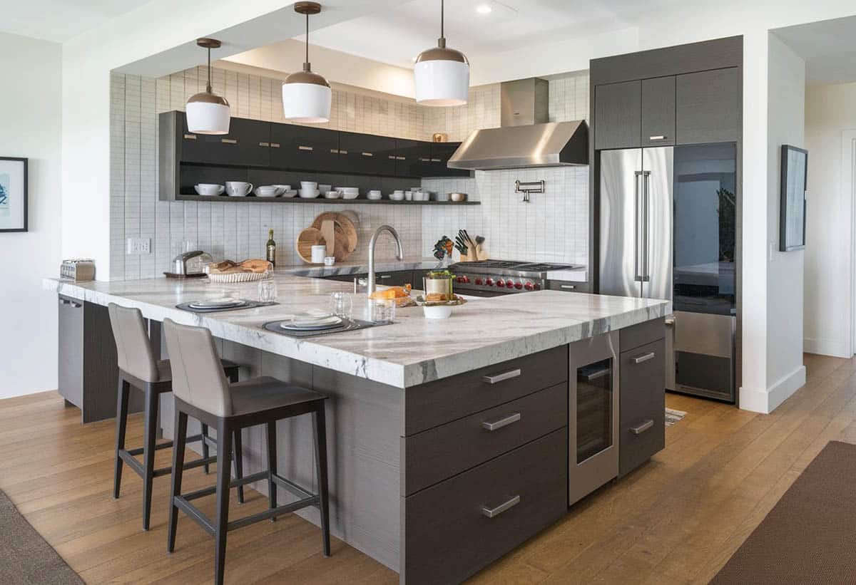kitchen with overhang peninsula, dark stain cabinets and mini pendants