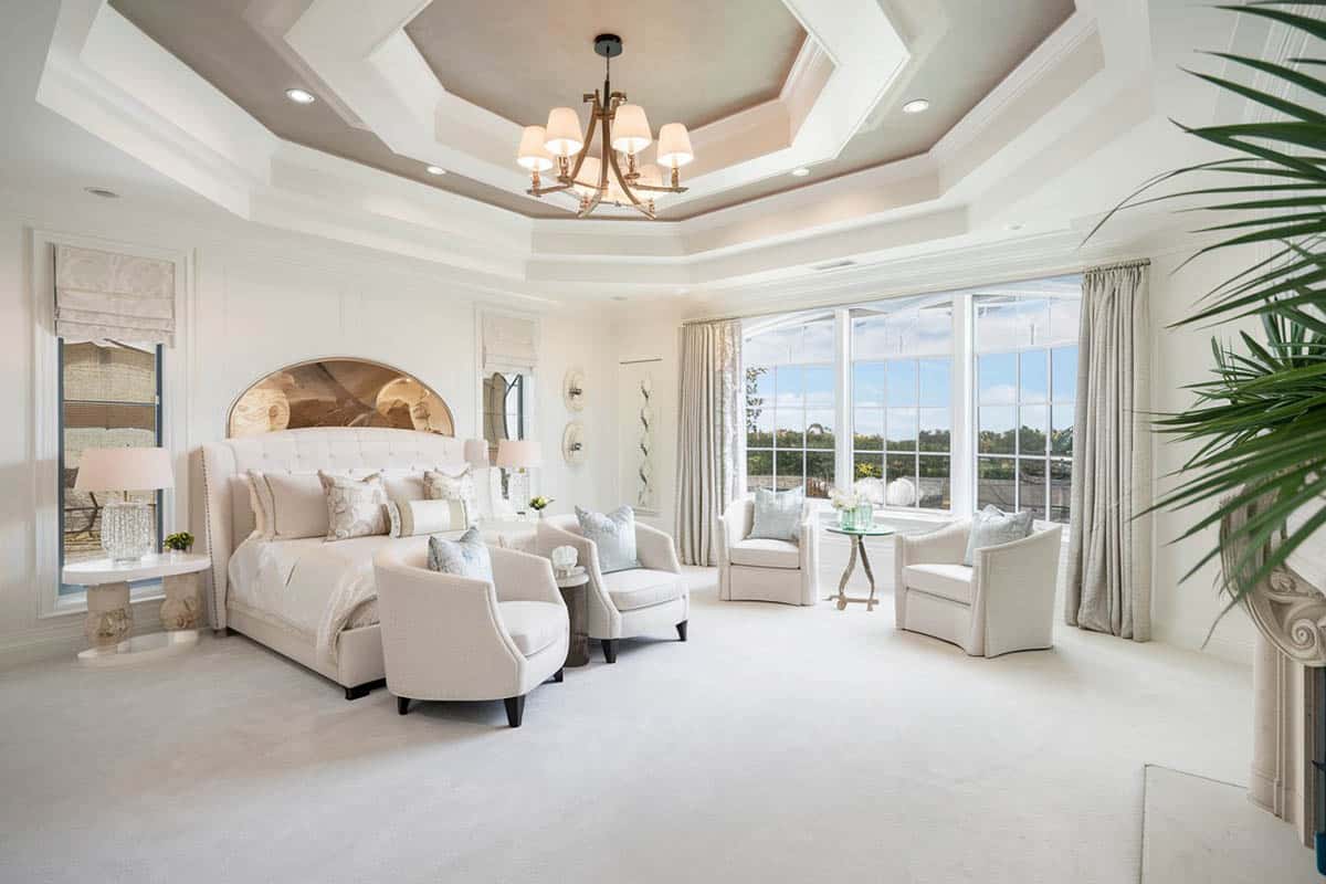 Luxury bedroom with plush bed and two tier tray ceiling