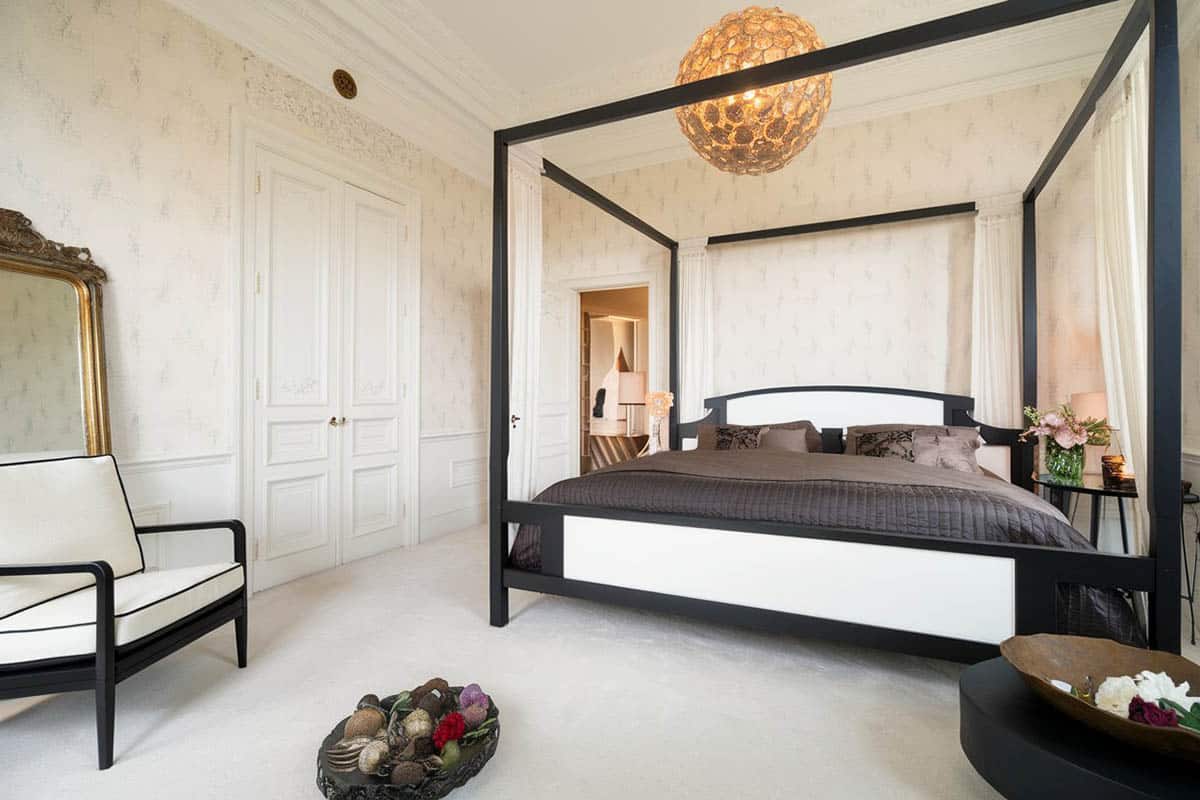 Bedroom with pattern wallpaper and canopy bed