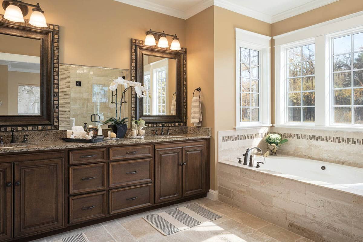 Bathroom with custom wooden vanity and tan paint