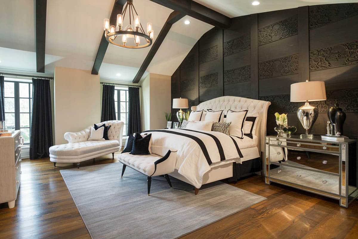 Elegant traditional bedroom with black patterned wall and chandelier