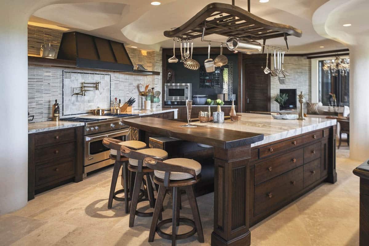 Rustic chefs kitchen with cabinets and wood bar for breakfast