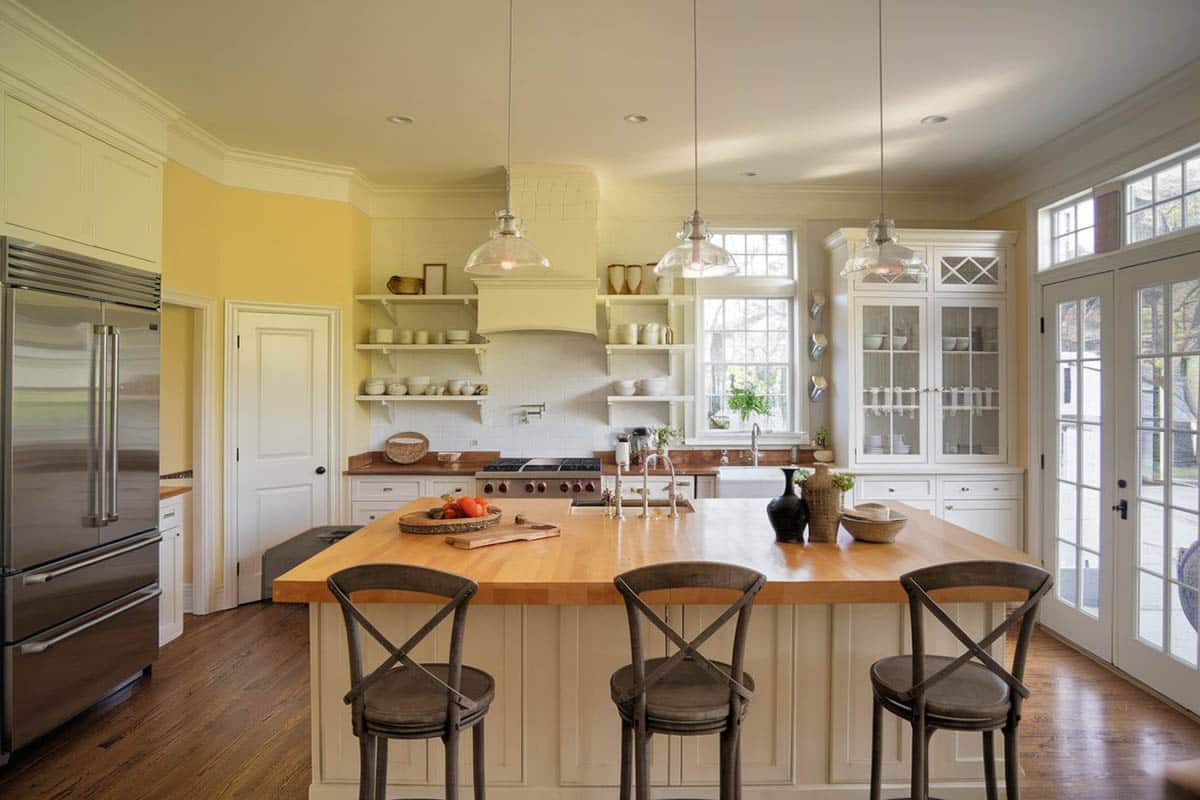Rustic country kitchen with open shelved cabinets and bare wood breakfast bar
