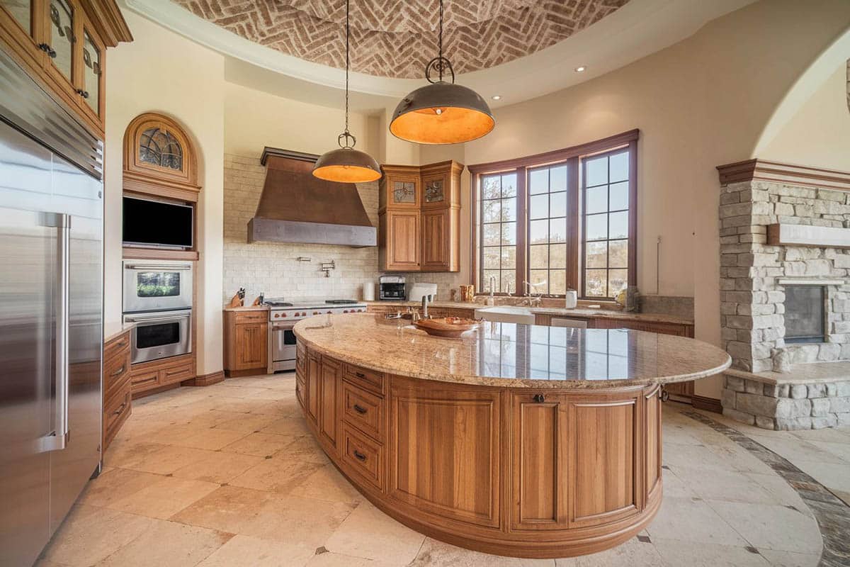 Kitchen with custom island, santa cecelia granite and tuscany chateaux travertine floor tile