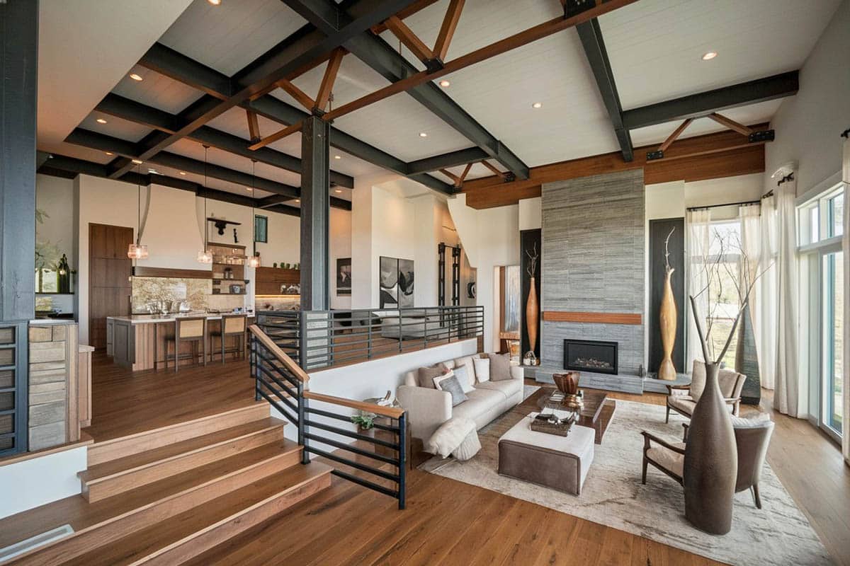 Room with wood floors, slate fireplace and high beam ceiling