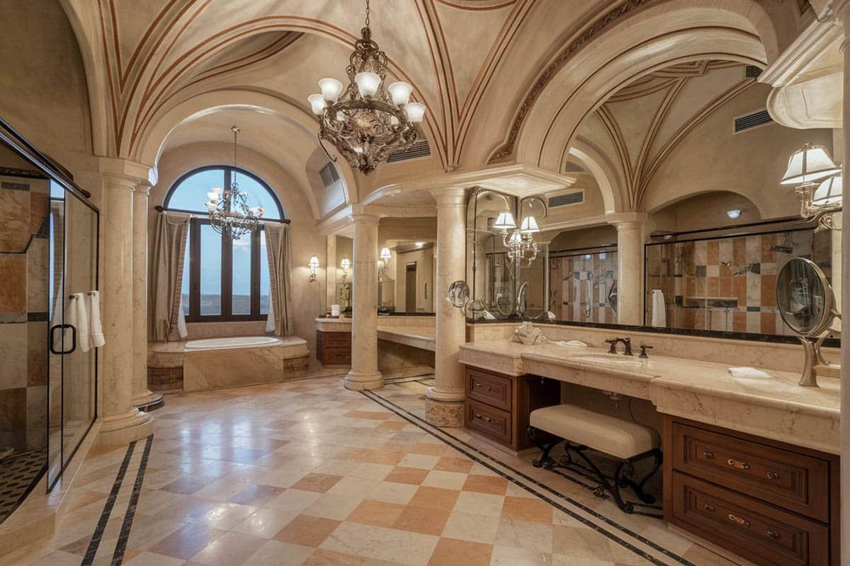 Brown bathroom with limestone tile, rustic vanity with copper sink and hardware