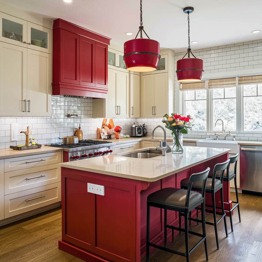 Cream and red cabinetry kitchen with island and drum pendant lights