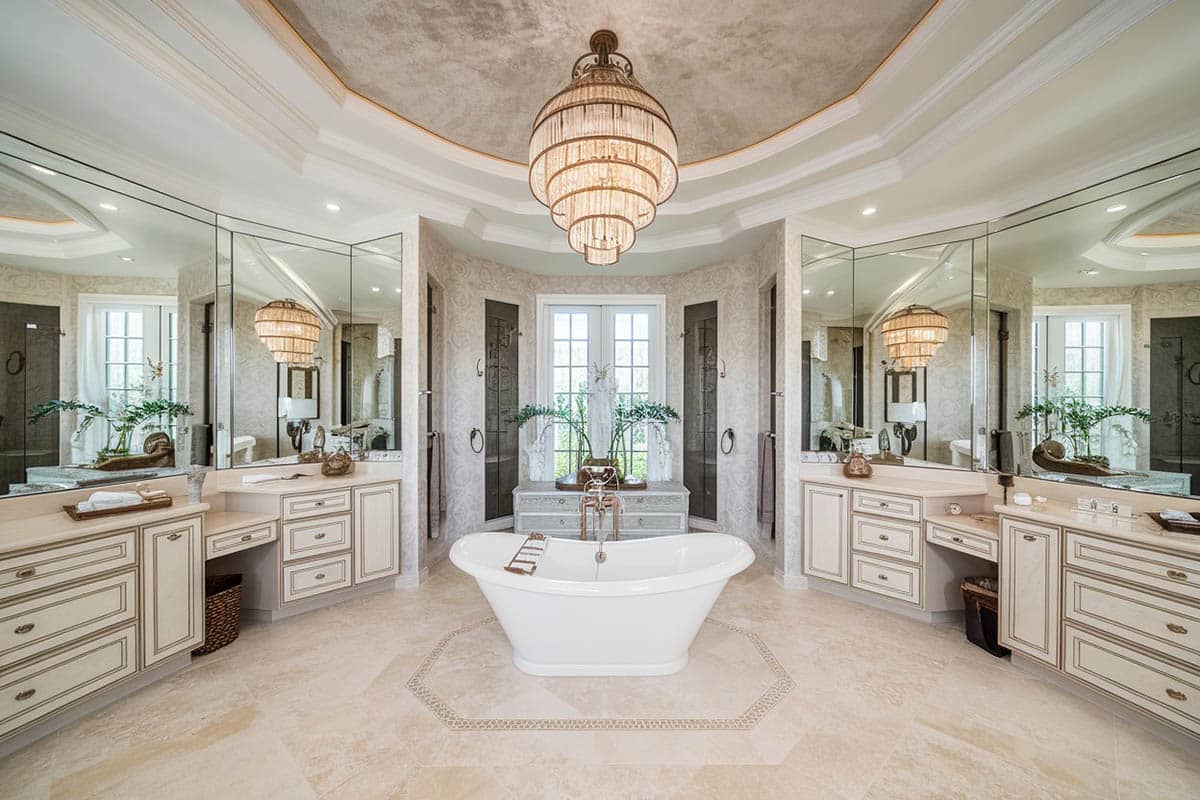 Expansive bathroom with central tub with large chandelier overhead