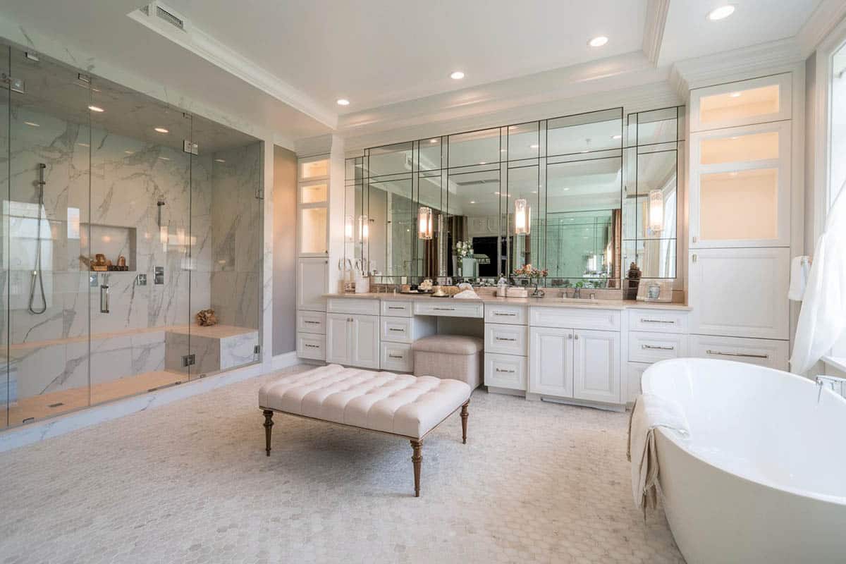 bathroom suite with white double sink vanity and large glass rainfall shower