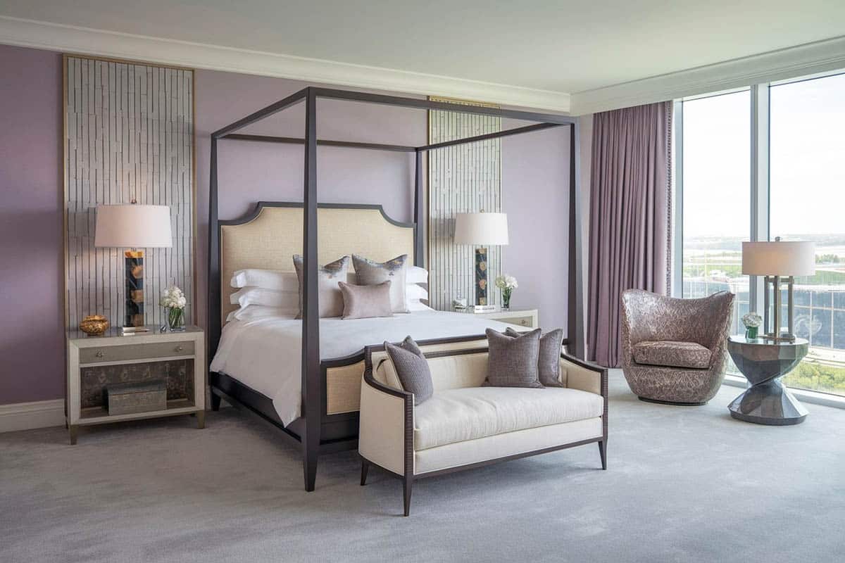 Contemporary bedroom with purple painted walls with cream accent detail panels and modern four post canopy bed