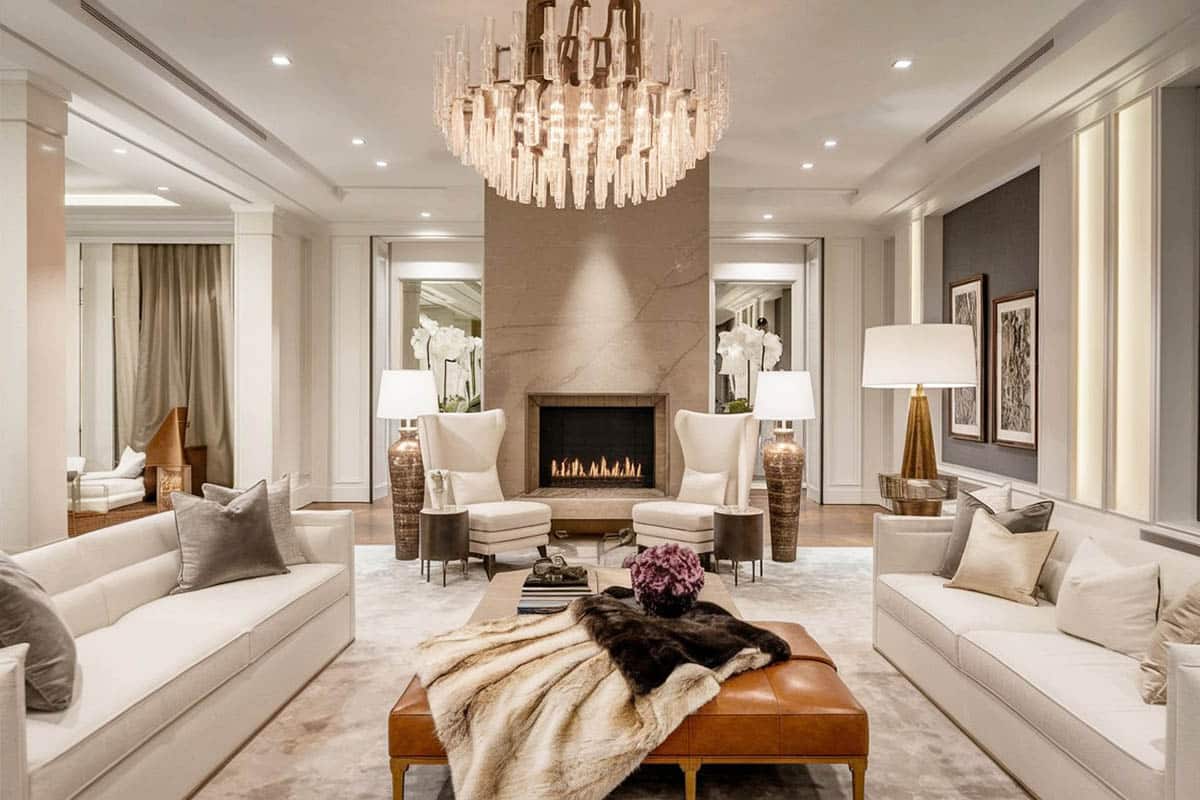 Brown leather ottoman, crystal chandelier and low back sofa facing each other