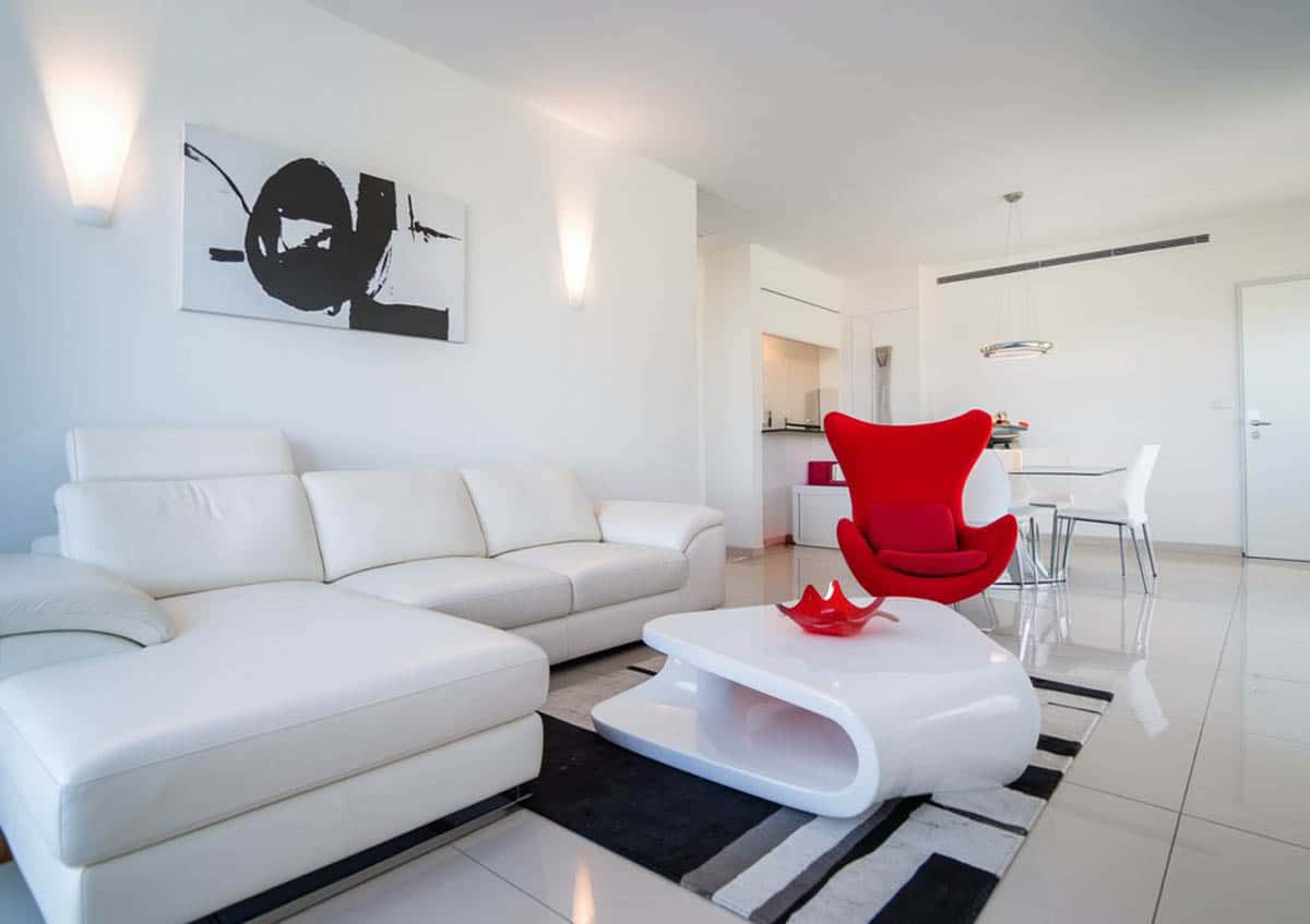 Room with porcelain tile flooring and bright red accent pieces