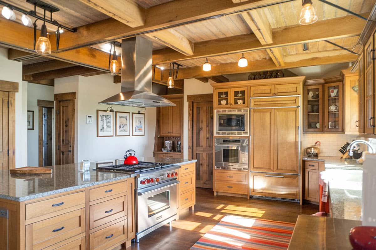 Kitchen with gray granite countertops and down lighting