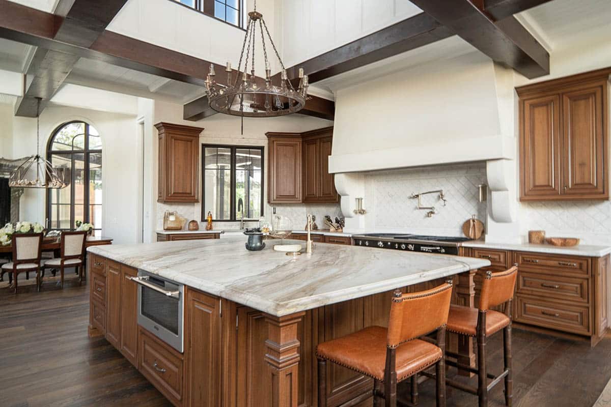 Tuscan inspired kitchen with white marble counter and dark finish floors