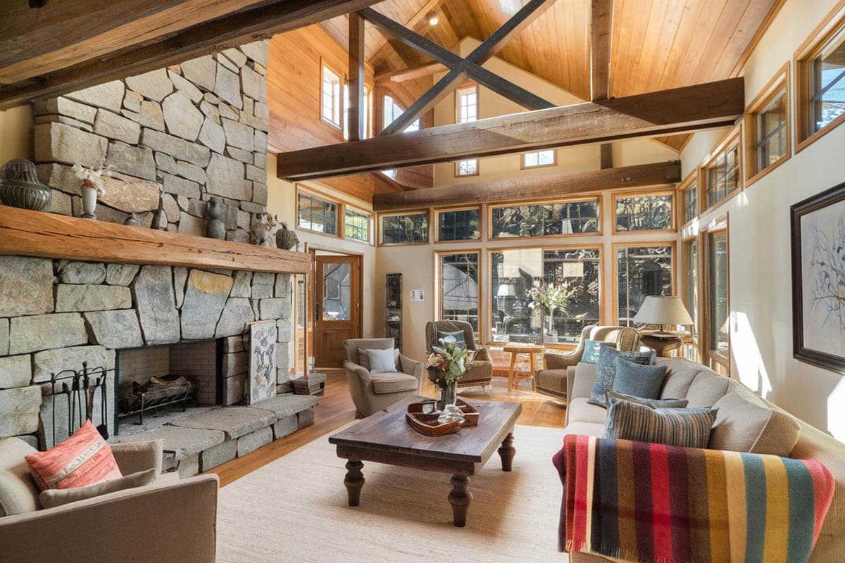Country room with rock fireplace, arched ceiling and large wood overhead beams