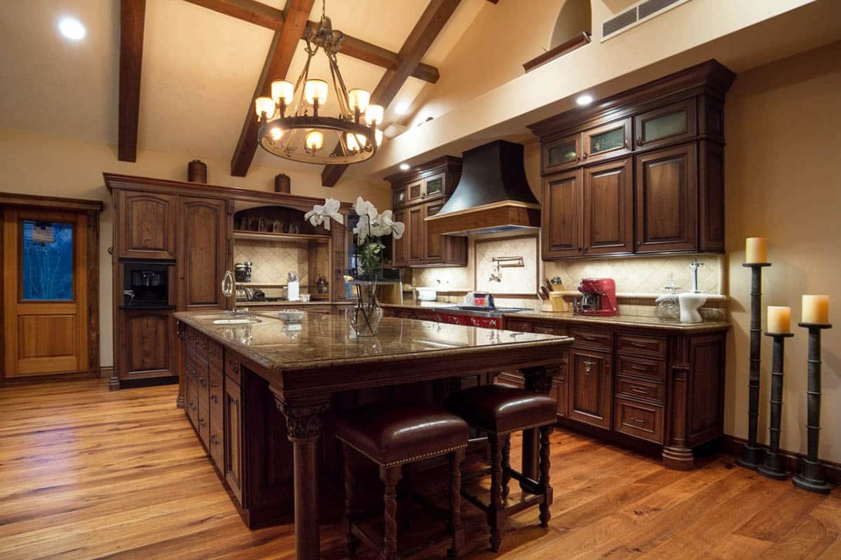 Italian kitchen with rustic metal chandelier and maple flooring