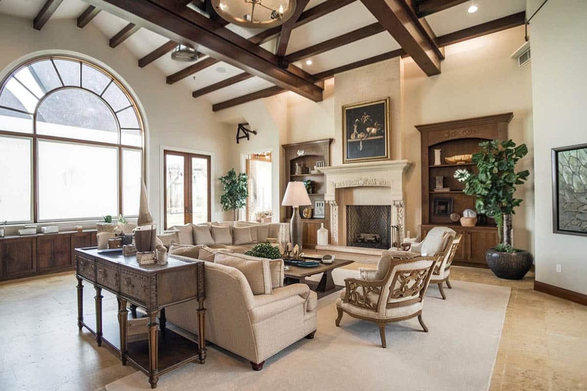 Rustic style room with vaulted ceiling, arched window and decorative fireplace