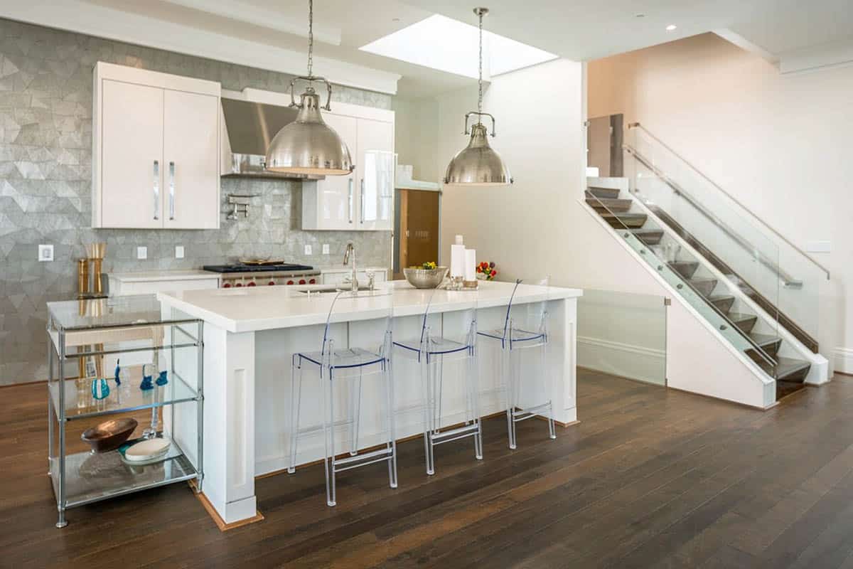 Kitchen with white cabinets, metal backsplash, engineered hardwood floors, and chrome pendant lights