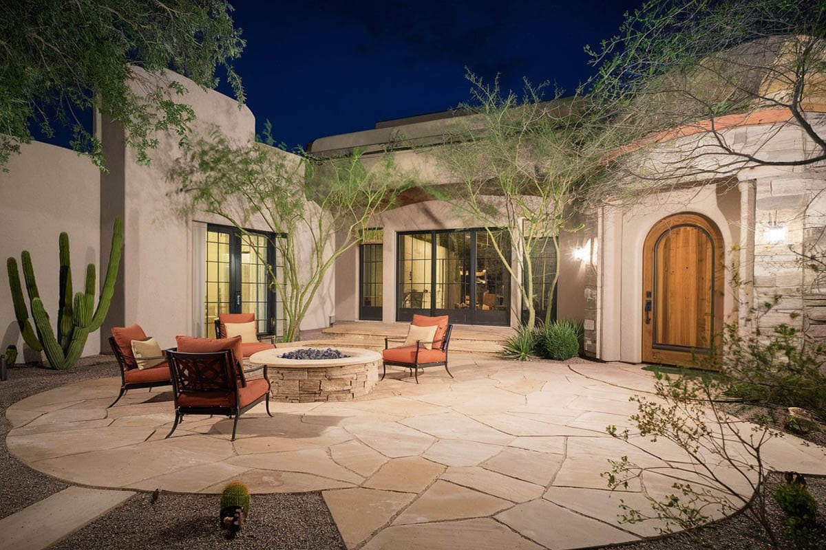 Mediterranean style patio with stacked stone firepit