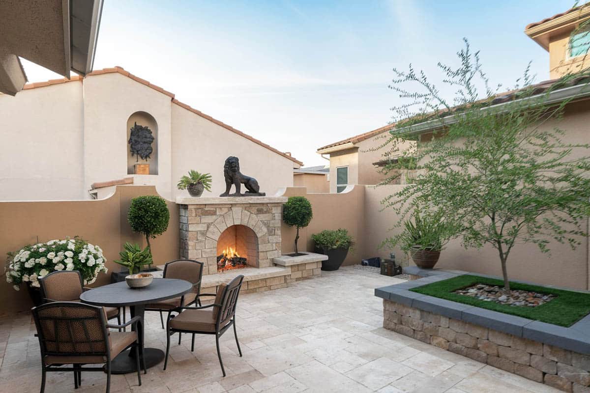 Patio with backyard fireplace and pavers