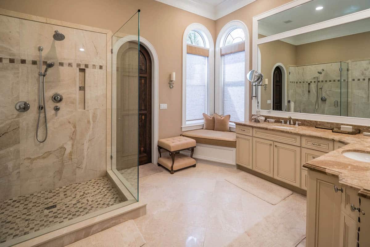 Luxury shower with travertine in cream color vanity bathroom