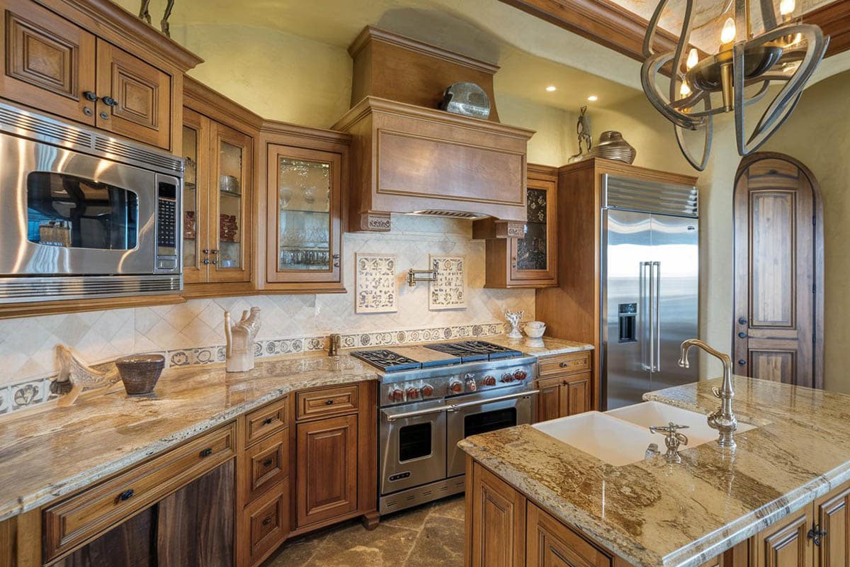 Kitchen with viking appliances, decorative backsplash and counter with sink