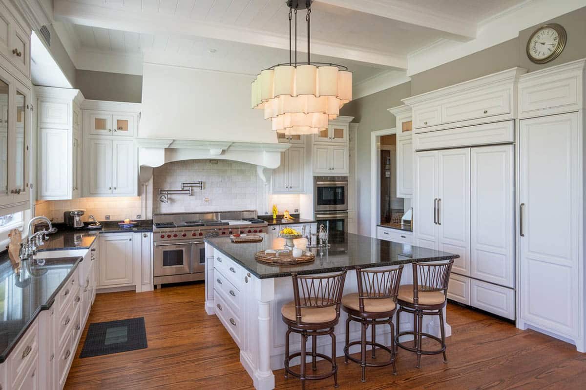 White cabinet kitchen with modern chandelier over island