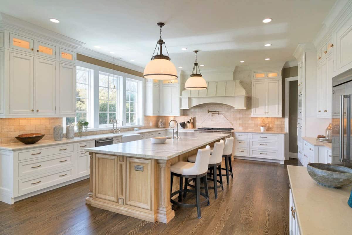 Kitchen with main cabinets painted white and marble counter top