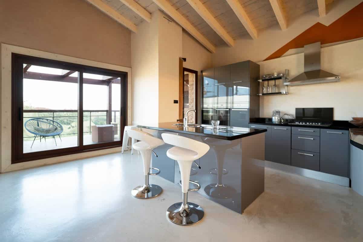 High ceiling kitchen with colored concrete flooring
