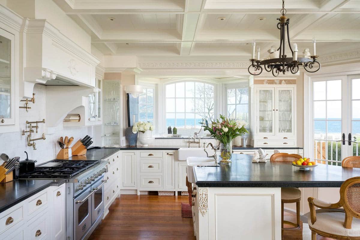 Traditional kitchen with angola black granite counters, curved breakfast bar island, chandelier and ocean views