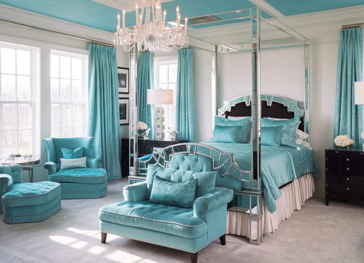 Beautiful teal color bedroom with chaise lounge, bed seat, and silver mirrored four post bed