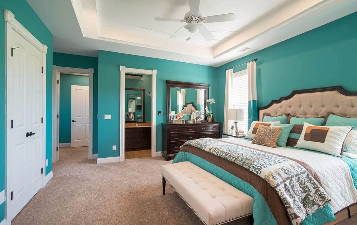 Bedroom with bright teal walls with tray ceiling