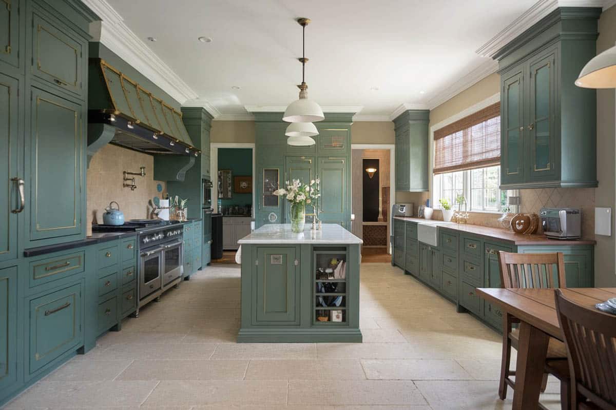 Kitchen with dark green cabinets, wood counters and breakfast bar nook