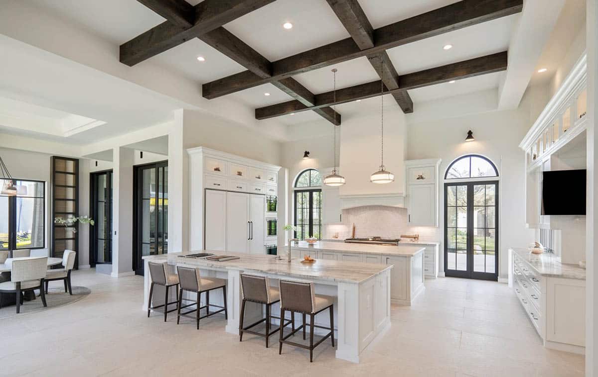 Kitchen with two islands, Carrara marble counters and wood beam ceiling