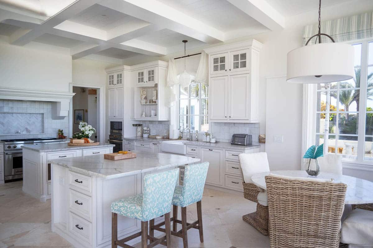 Damasco white marble counters and white cabinetry with glass doors