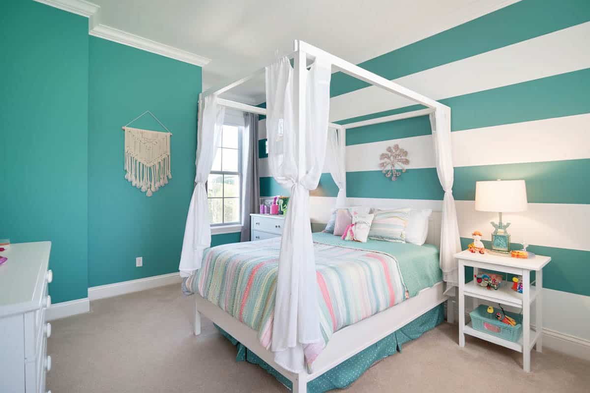 Teal and white striped wall bedroom design with four post bed